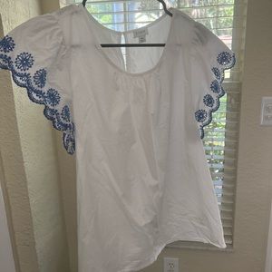 White blouse with blue floral cut outs